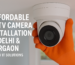 Technician installing a dome CCTV camera with orange gloves in a modern indoor space, promoting affordable CCTV installation in Delhi and Gurgaon by Dev IT Solutions.
